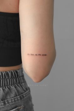 the back of a woman's arm with an inscription on it