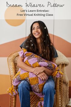 a woman sitting in a chair holding a pillow