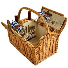 two wicker picnic baskets with utensils and wine glasses in them on a white background