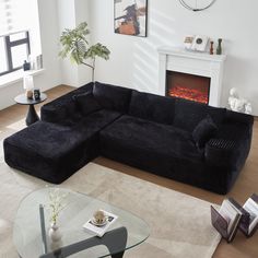 a living room filled with furniture and a fire place next to a wall mounted fireplace