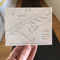 a hand holding up a white map card