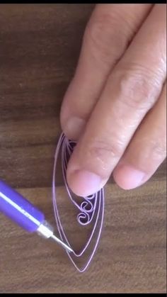 a person is working with some string on a piece of wood