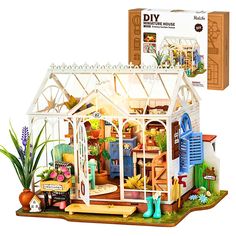 a diy model of a house with lots of plants and flowers in the yard