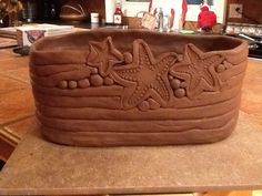 a large brown pot sitting on top of a counter