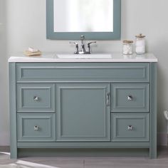 a bathroom vanity with a mirror above it