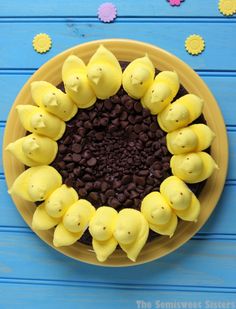 a yellow plate topped with chocolate chips and peep holes