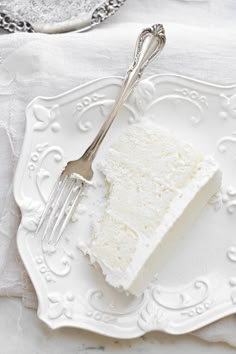 a piece of cake sitting on top of a white plate next to a knife and fork