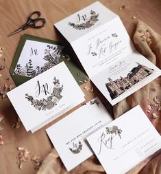 the wedding stationery is laid out on the table