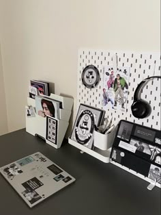 a desk with some pictures and headphones on it