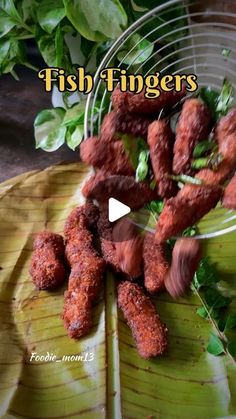 fried fish fingers on a banana leaf with the words fish fingers in front of it