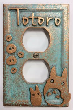 an old light switch plate with two cats and a dog on it