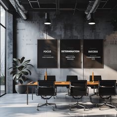 an empty conference room with black chairs and posters on the wall, along with a potted plant