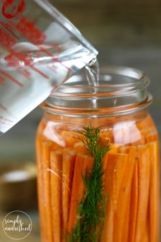 a jar filled with carrots sitting on top of a table