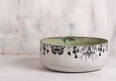 a white bowl with black designs on it