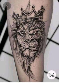 a lion with a crown on his head tattooing it's legs and leg