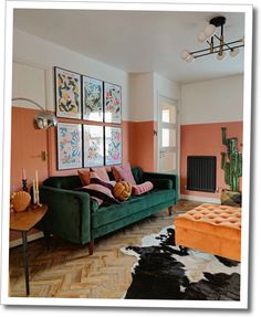 a living room filled with furniture and paintings on the wall