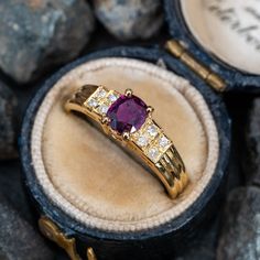 This pretty ring is centered with one (1) cushion cut natural ruby set into a four-prong setting. The shoulders of the ring are each accented with four (4), bead set, round brilliant cut diamonds. The ring measures 5.9mm at the top, rises 5.1mm above the finger, tapering to 2.1mm wide and 0.7mm thick at the base of the shank. This ring is currently a size 6. There is a tiny nick on the ruby but nothing noticeable that distracts from its beauty. Classic Ruby Ring With Single Cut Diamonds, Formal Princess Cut Ruby Ring With Center Stone, Ruby Rings With Single Cut Diamonds, Ruby Rings With Round Cut Single Diamonds, Formal Ruby Diamond Ring With Single Cut Diamonds, Formal Asscher Cut Ruby Ring With Diamonds, Formal Asscher Cut Ruby Ring With Center Stone, Classic Ruby Ring With Single Cut Diamonds For Promise, Luxury Ruby Diamond Ring With Accent Stones