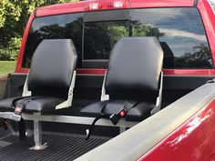 two seats in the back of a red truck