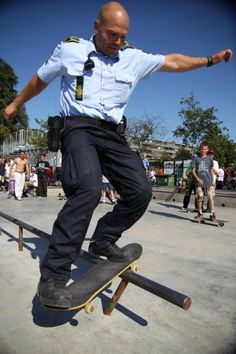 a man riding a skateboard on top of a rail