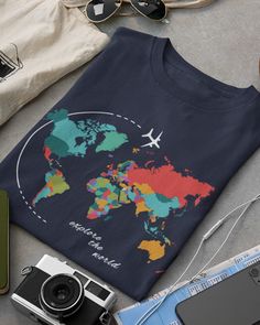 "World Map Shirt, Adventure Shirt, Geography Shirt, Wanderlust Shirt, Vacation Shirt, Unisex shirt, Travel Shirt, Travel Gift, Adventure Tee ▸ H O W  T O  O R D E R ◂ 1. Please, Check and Review all Photos. 2. Select Your T-Shirt Size and T-Shirt Color from the drop-down menus.* 3. Choose Your Quantity as much as you want. 4. Click ADD TO CART. You can go back to add more product colors for your family members anytime you want, or you can complete the checkout process. 5. Please click the \"Proceed to Check Out\" button. * If you want a colored t-shirt it's not in the drop-down menus.     Please send me a message with the color and size you want to check if is available. ▸ S I Z I N G ◂ * Sizing is UNISEX so runs like men's in the selection, though not overly large * Most women find their Travel T-shirt, Travel T Shirts Ideas, Travel T-shirts, Travel T Shirt, Travel T Shirt Design, Graphic Tee With Crew Neck For Travel, Graphic Print Short Sleeve T-shirt For Travel, Cotton Short Sleeve T-shirt For Travel, Cotton Travel Tops With Letter Print