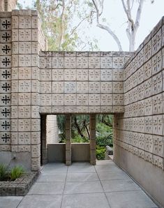 an outdoor courtyard with cement blocks and trees