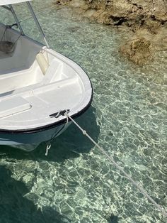 a small boat tied up to the shore