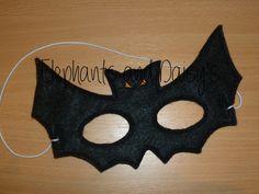 a black cat mask is sitting on a table