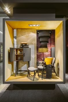 a room that has some chairs and speakers in it with yellow accents on the walls