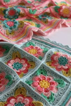 a crocheted blanket with flowers on it