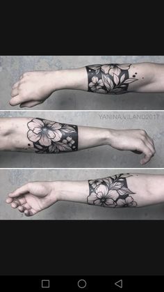 the arm is covered in black ink with flowers and leaves on it, as well as an