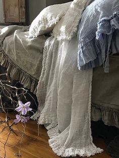 a bed with ruffled bedspread and pillows