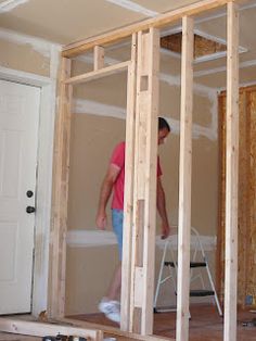 a man standing inside of a room under construction