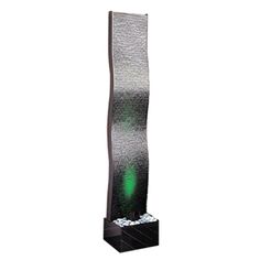 a tall water fountain with green lights on the top and black base, in front of a white background