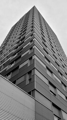 a very tall building with lots of windows on it's side in black and white