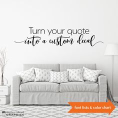 a living room with a couch and wall decal that says, turn your quote into a