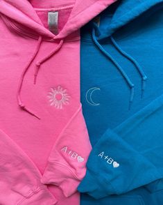 two blue and pink hoodies sitting next to each other