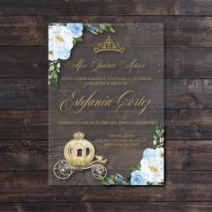 an elegant wedding card with flowers and carriage on the front, is displayed against a wooden background