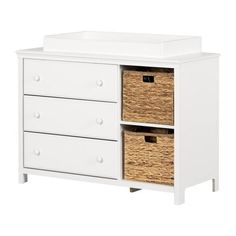 a white dresser with two baskets on top and one drawer open to show the drawers