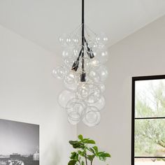 a living room with a couch, coffee table and chandelier hanging from the ceiling