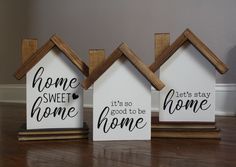 three small wooden houses with the words home, it's so good to be home