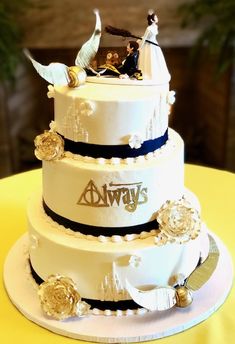 a three tiered wedding cake decorated with figurines