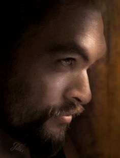 a close up of a man with a beard wearing a suit and bow tie looking off into the distance