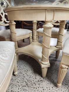 a dining room table with chairs and a bench in the middle on a carpeted floor