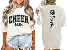 Celebrate your cheerleader with our varsity-style "cheer mom" shirt, featuring bold letters on the front. The back showcases a pom pom and is personalized with your cheerleader's name, making it the perfect gift for any proud cheer mom or mama passionate about cheerleading. COMFORT COLORS 1717 SHIRT: Unisex 100% US cotton - ethically grown and harvested Pre-Shrunk Fabric Relaxed Fit - Size up for a trendy oversized look Seamless Sides Double Needle Stitching Garment-dyed  CARE INSTRUCTIONS: Wash Cheer Shirt Ideas Design, Cheer Mom Era Shirt, Cheer Fan Shirts, Cheer Family Shirts, Cheer Grandma Shirt Ideas, Team Spirit Cheerleading Tops With Text Print, Cheerleading Text Print Tops With Team Spirit, Varsity Fan Gear T-shirt With Lettering, Varsity Style Fan Gear T-shirt With Lettering