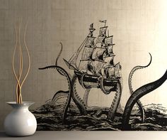 an octopus attacking a pirate ship wall decal in a room with a white vase