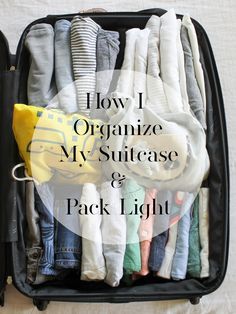 an open suitcase filled with clothes and the words how i organize my suitcase & pack light