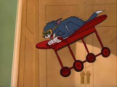 a cartoon cat riding on top of a red airplane