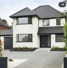 a large white house with black trim and windows