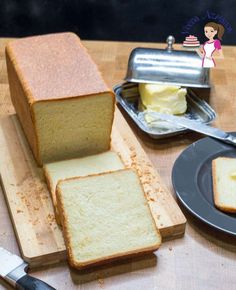 a loaf of bread sitting on top of a wooden cutting board next to a knife