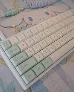 a keyboard and mouse sitting on top of a blue and white tablecloth with flowers